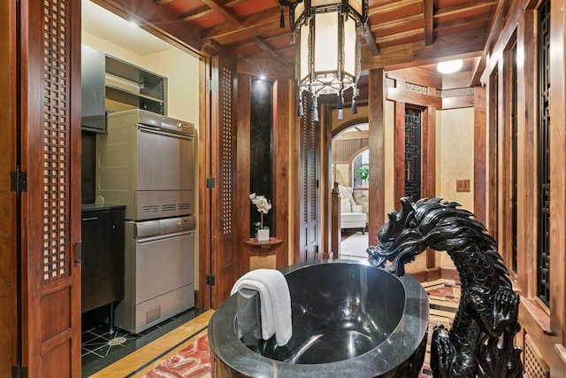 8 Grove St Unit 8B, Minneapolis, MN 55401 - bathroom with stacked washer / dryer and a chandelier