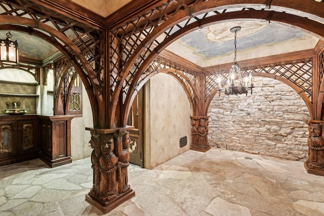 8 Grove St Unit 8B, Minneapolis, MN 55401 - wine area featuring arched walkways, stone floors, and a chandelier