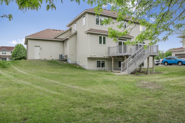 10543 Noble Cir N, Brooklyn Park, MN 55443 - rear view of property with a deck, central air condition unit, a yard, stairway, and a shingled roof