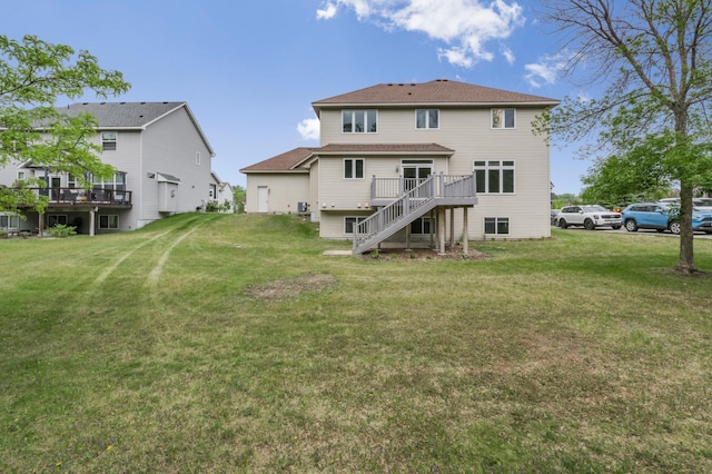 10543 Noble Cir N, Brooklyn Park, MN 55443 - back of house featuring stairs, a wooden deck, a lawn, and a shingled roof