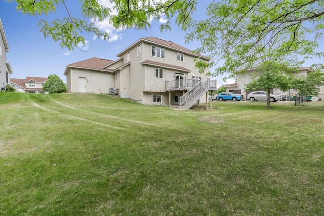 10543 Noble Cir N, Brooklyn Park, MN 55443 - back of house featuring a wooden deck, stairway, and a yard
