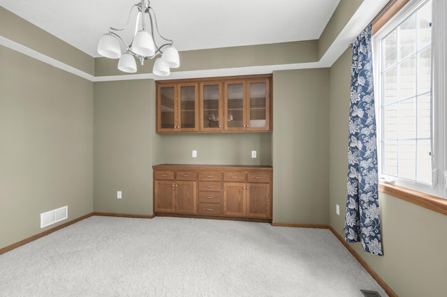 10543 Noble Cir N, Brooklyn Park, MN 55443 - empty room with a chandelier, baseboards, and light carpet