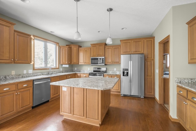 10543 Noble Cir N, Brooklyn Park, MN 55443 - kitchen featuring stainless steel appliances, a sink, dark wood-style flooring, a kitchen island, and brown cabinets