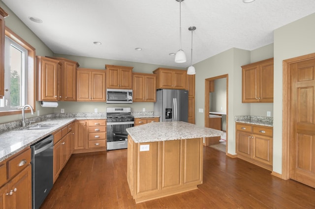 10543 Noble Cir N, Brooklyn Park, MN 55443 - kitchen featuring stainless steel appliances, a sink, dark wood finished floors, a kitchen island, and light stone countertops