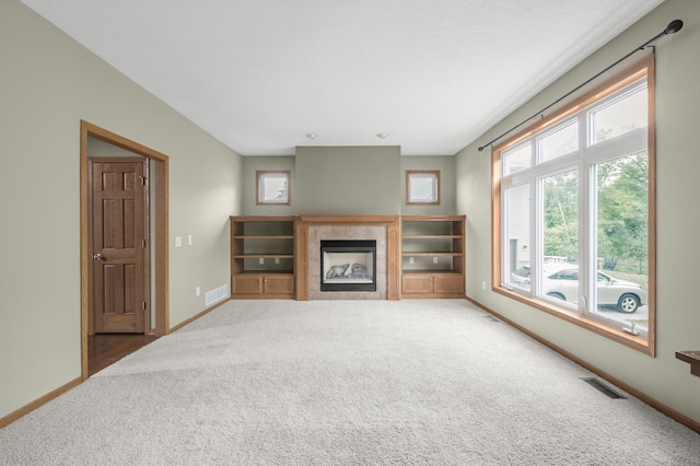 10543 Noble Cir N, Brooklyn Park, MN 55443 - unfurnished living room featuring carpet flooring, a tiled fireplace, and baseboards