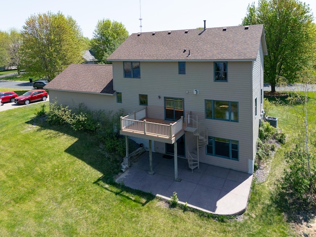 761 Country Lakes Dr, Lino Lakes, MN 55014 - rear view of house featuring central AC unit, a yard, a patio area, a wooden deck, and a shingled roof
