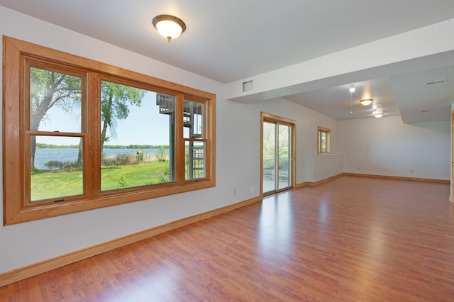 761 Country Lakes Dr, Lino Lakes, MN 55014 - unfurnished room with baseboards, a water view, and light wood finished floors
