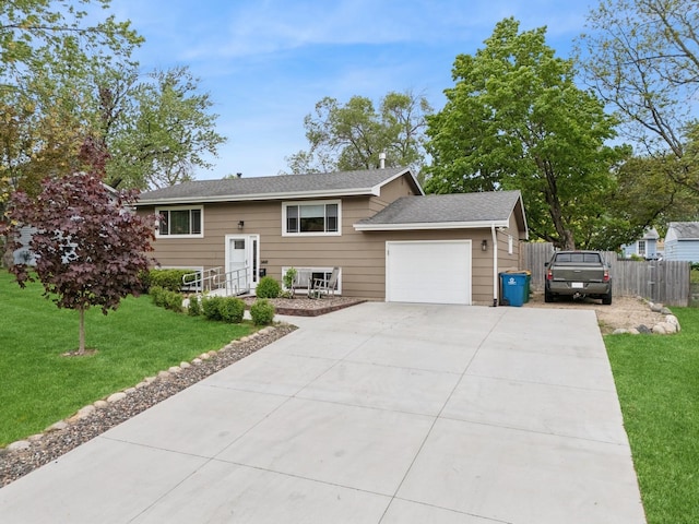 3807 Independence Ave N, New Hope, MN 55427 - split foyer home featuring a garage, concrete driveway, and roof with shingles