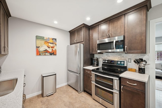 3807 Independence Ave N, New Hope, MN 55427 - kitchen with stainless steel appliances, dark brown cabinets, backsplash, recessed lighting, and baseboards
