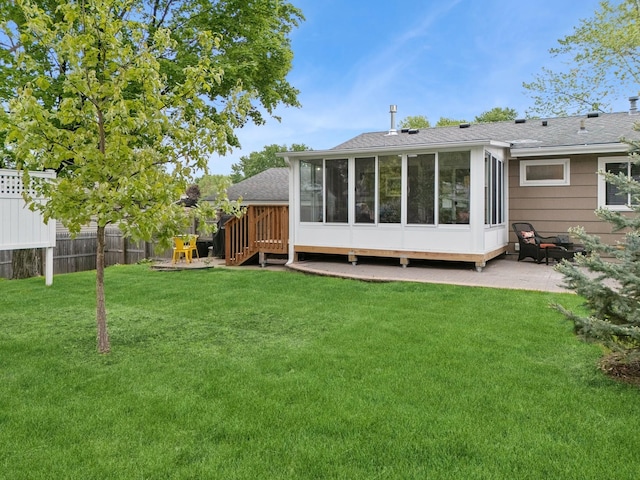 3807 Independence Ave N, New Hope, MN 55427 - rear view of property featuring a sunroom, a patio area, and roof with shingles