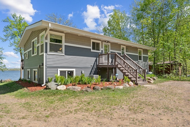 view of front of property featuring stairway and a water view