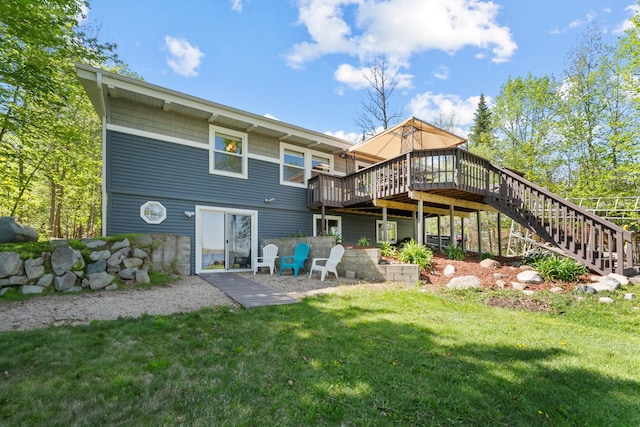 rear view of property with a wooden deck, a lawn, and stairs