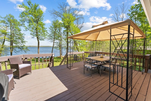 deck featuring a water view and outdoor dining area