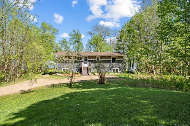 rear view of property with a yard