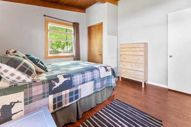 bedroom with hardwood / wood-style flooring, baseboards, wooden ceiling, and beamed ceiling