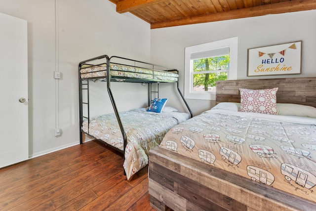 bedroom with wood ceiling, wood finished floors, baseboards, and beam ceiling