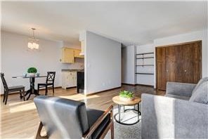 709 11th Ave S Unit 5, Hopkins, MN 55343 - living area with a chandelier and wood finished floors