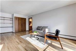 709 11th Ave S Unit 5, Hopkins, MN 55343 - sitting room with wood finished floors and baseboards