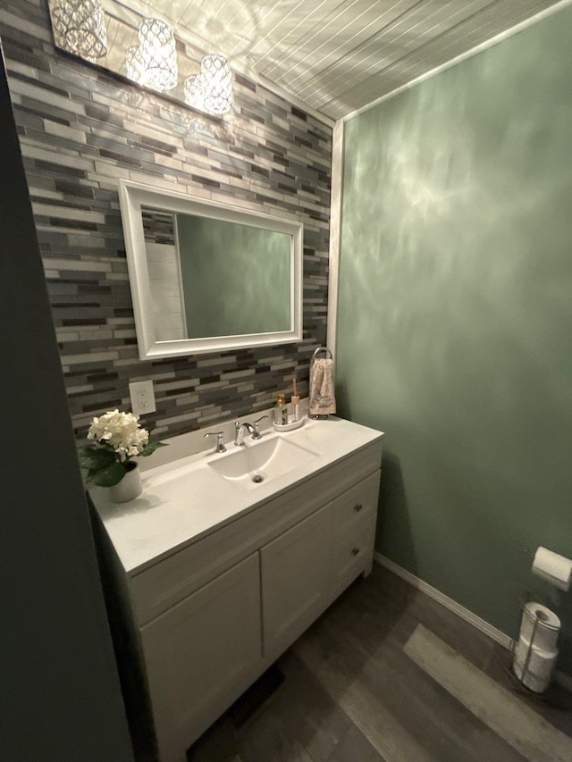 16161 6th St N, Lakeland, MN 55043 - bathroom with vanity, backsplash, wood finished floors, and baseboards