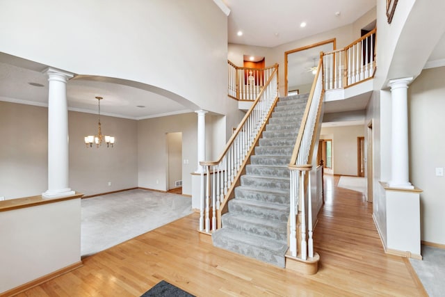 3613 Clare Downs Path, Rosemount, MN 55068 - stairs with wood finished floors, baseboards, decorative columns, a towering ceiling, and ornamental molding