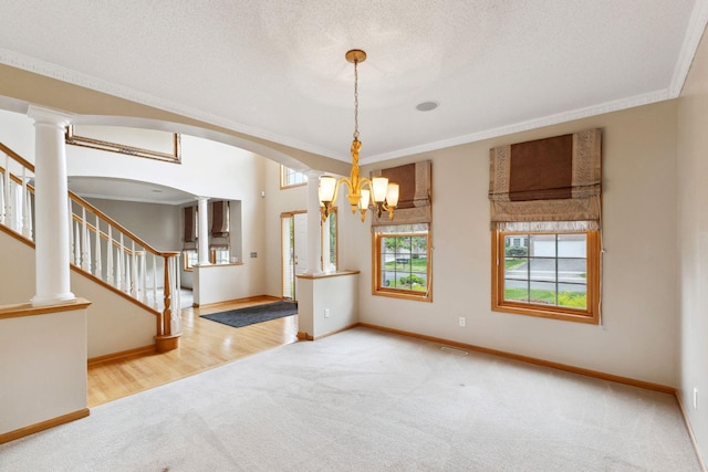 3613 Clare Downs Path, Rosemount, MN 55068 - unfurnished room featuring carpet floors, baseboards, crown molding, stairway, and a chandelier