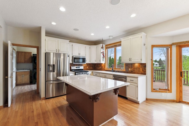 3613 Clare Downs Path, Rosemount, MN 55068 - kitchen with stainless steel appliances, light wood-type flooring, healthy amount of natural light, a sink, and recessed lighting