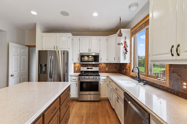 3613 Clare Downs Path, Rosemount, MN 55068 - kitchen featuring stainless steel appliances, a sink, light stone counters, white cabinetry, and recessed lighting