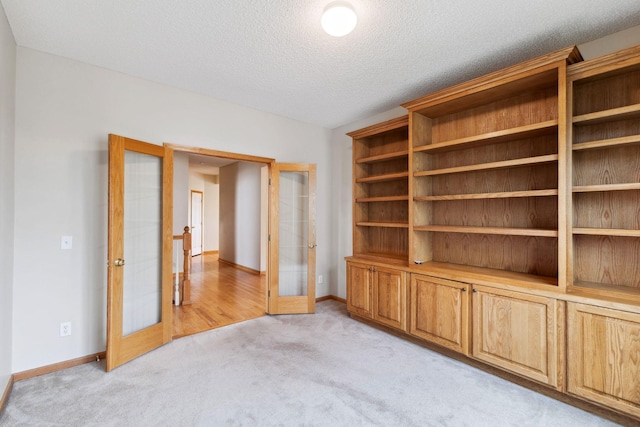 3613 Clare Downs Path, Rosemount, MN 55068 - unfurnished room featuring french doors, light colored carpet, baseboards, and a textured ceiling
