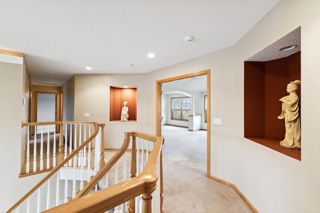 3613 Clare Downs Path, Rosemount, MN 55068 - hall with carpet flooring, an upstairs landing, a textured ceiling, recessed lighting, and arched walkways