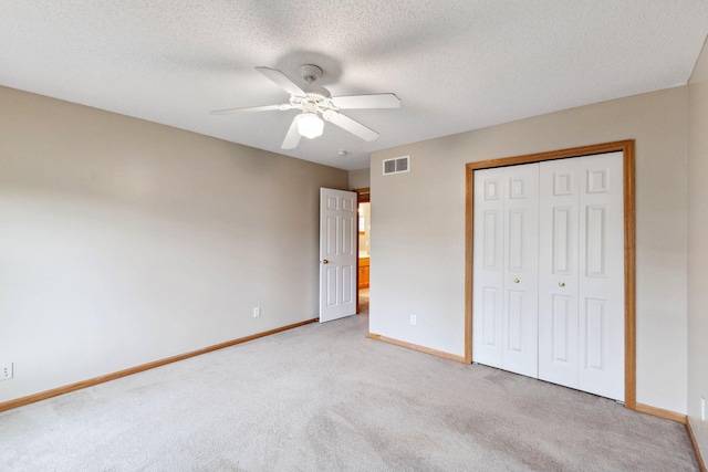 3613 Clare Downs Path, Rosemount, MN 55068 - unfurnished bedroom with light colored carpet, baseboards, a closet, a textured ceiling, and a ceiling fan