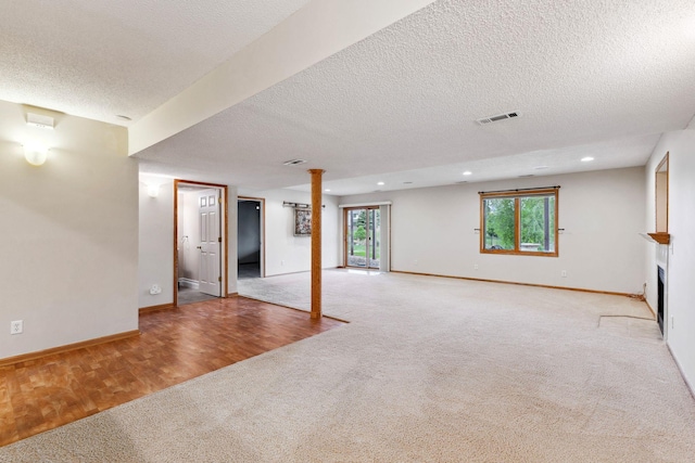 3613 Clare Downs Path, Rosemount, MN 55068 - below grade area featuring carpet flooring, a textured ceiling, baseboards, recessed lighting, and a fireplace