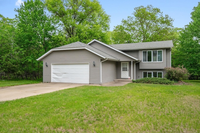 split level home featuring a garage, concrete driveway, a front yard, and roof with shingles
