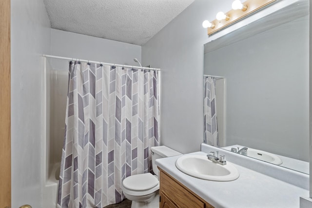 bathroom featuring a textured ceiling, toilet, vanity, and shower / bath combo