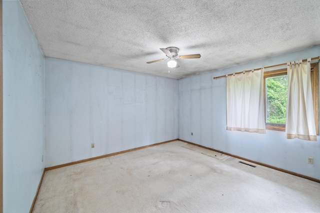 spare room with ceiling fan, baseboards, a textured ceiling, and carpet floors