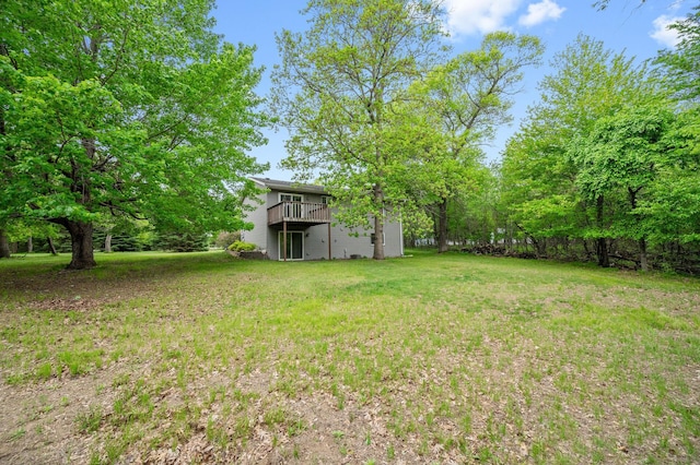 view of grassy yard with a deck
