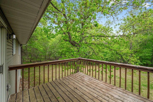 wooden terrace featuring a lawn