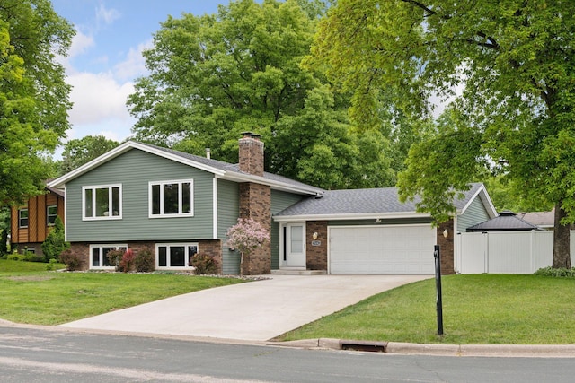 15243 Bluedorn Cir SE, Prior Lake, MN 55372 - tri-level home featuring a garage, concrete driveway, a chimney, brick siding, and a shingled roof