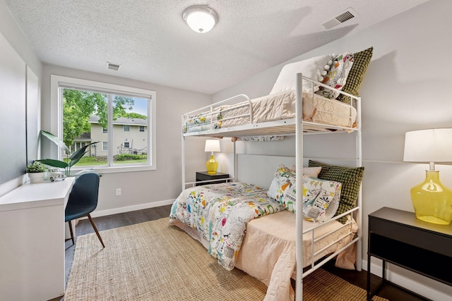 15243 Bluedorn Cir SE, Prior Lake, MN 55372 - bedroom with wood finished floors, a textured ceiling, and baseboards