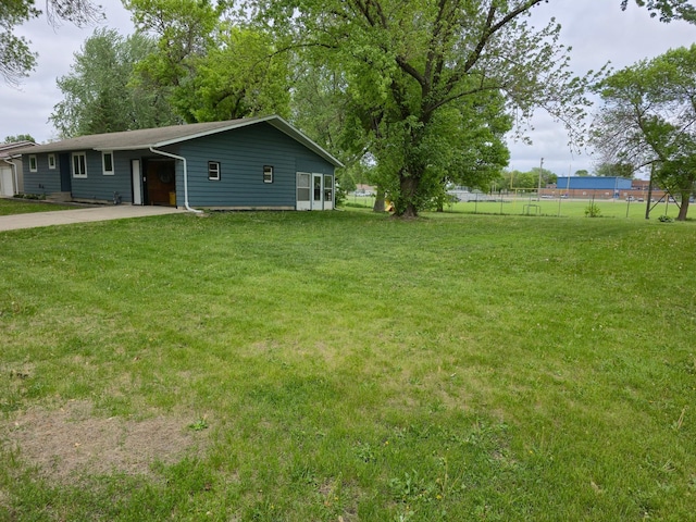 214 Central Ave, Truman, MN 56088 - view of yard with driveway and a carport