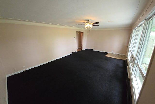 214 Central Ave, Truman, MN 56088 - empty room featuring baseboards, plenty of natural light, a ceiling fan, ornamental molding, and dark colored carpet