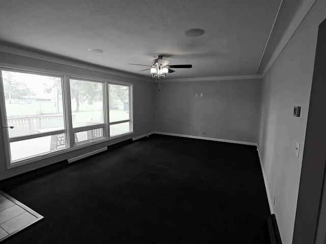 214 Central Ave, Truman, MN 56088 - unfurnished room with dark carpet, ceiling fan, and baseboards