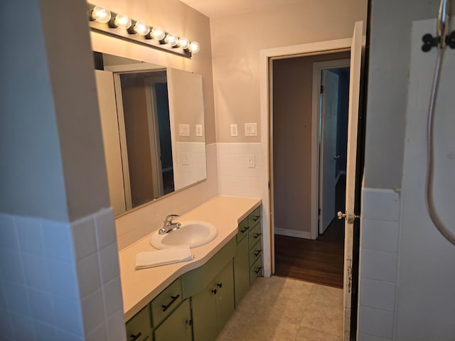 214 Central Ave, Truman, MN 56088 - bathroom featuring vanity, a wainscoted wall, and tile walls