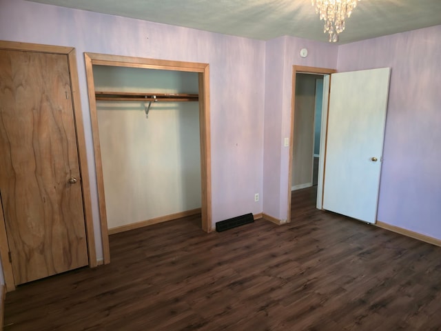214 Central Ave, Truman, MN 56088 - unfurnished bedroom with dark wood-style floors, baseboards, a chandelier, and a closet