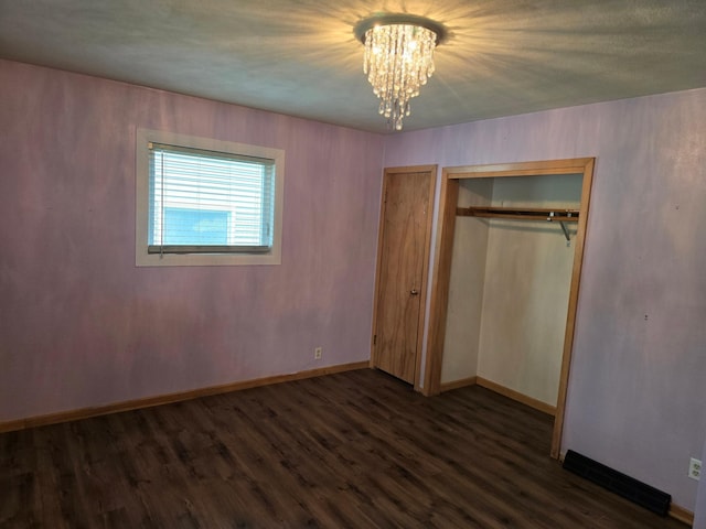 214 Central Ave, Truman, MN 56088 - unfurnished bedroom featuring a chandelier, wood finished floors, a closet, and baseboards