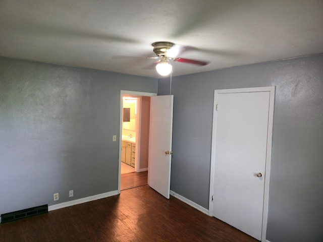214 Central Ave, Truman, MN 56088 - unfurnished bedroom with wood finished floors, baseboards, and a ceiling fan