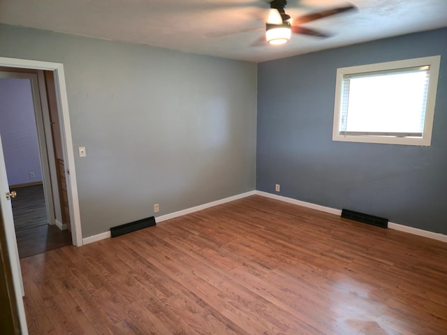 214 Central Ave, Truman, MN 56088 - unfurnished room featuring ceiling fan, wood finished floors, and baseboards