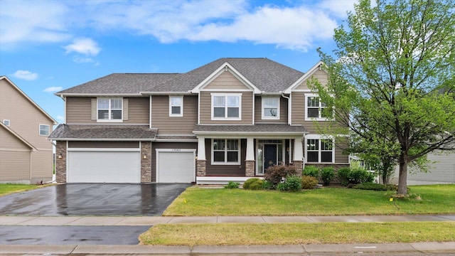 15365 Eagle Creek Way, Apple Valley, MN 55124 - view of front facade with driveway, a garage, a front yard, a shingled roof, and covered porch