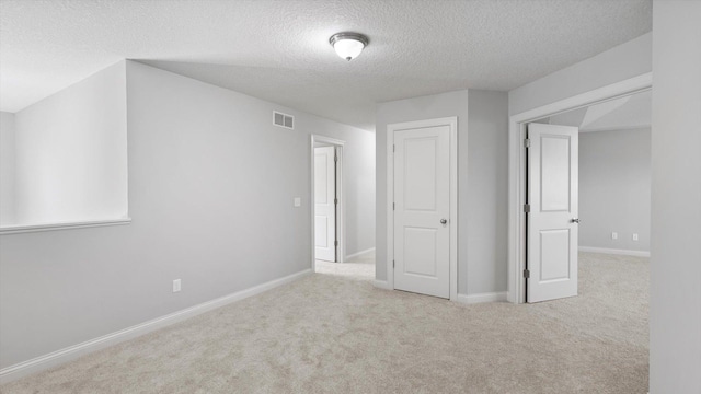 15365 Eagle Creek Way, Apple Valley, MN 55124 - spare room with a textured ceiling, carpet floors, and baseboards