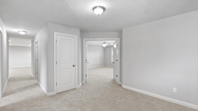 15365 Eagle Creek Way, Apple Valley, MN 55124 - hallway featuring a textured ceiling, light colored carpet, and baseboards