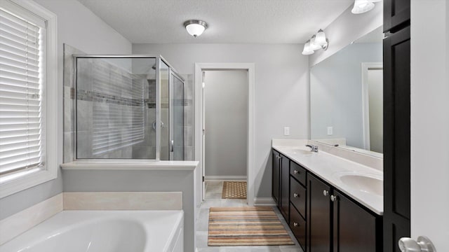15365 Eagle Creek Way, Apple Valley, MN 55124 - bathroom featuring a shower stall, double vanity, a garden tub, and a textured ceiling